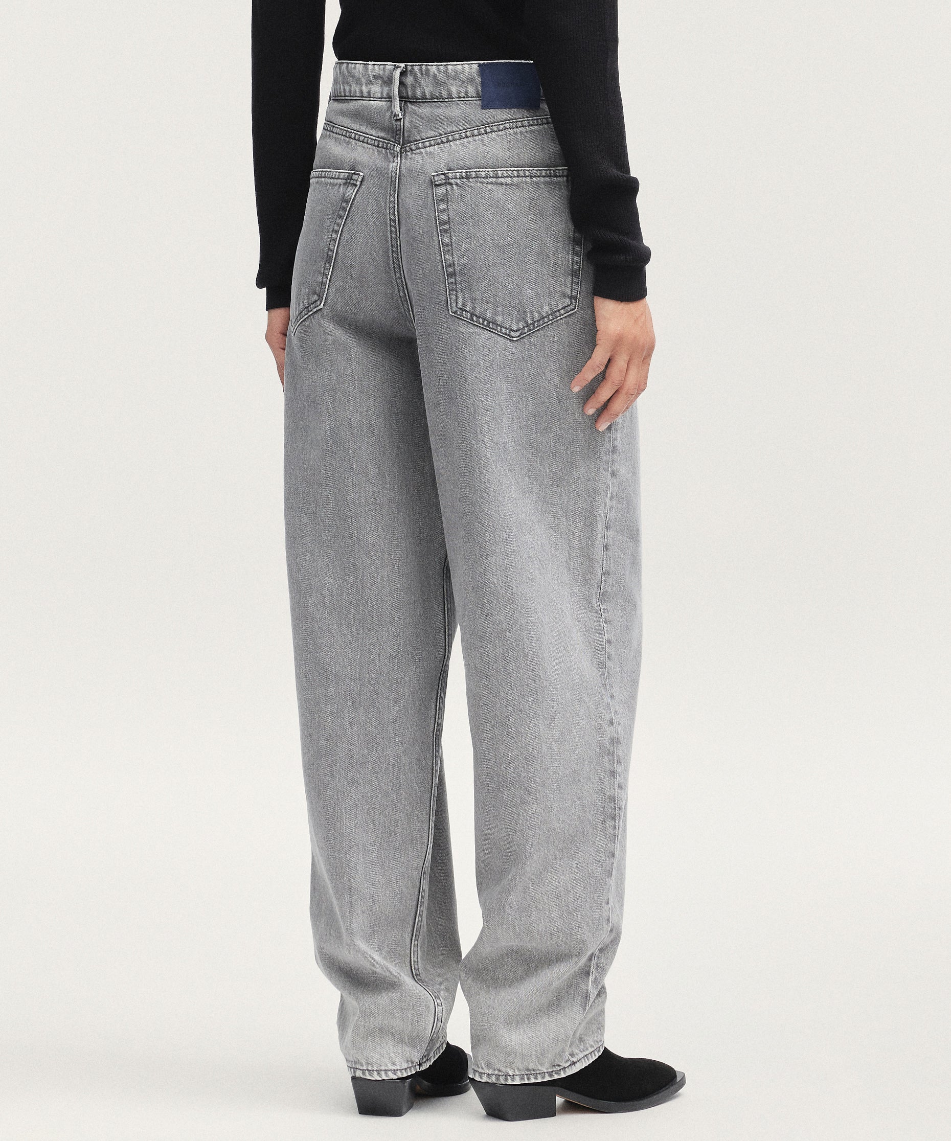 Person wearing gray jeans on a white background