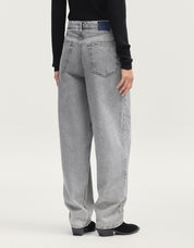 Person wearing gray jeans on a white background