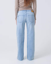 Light blue jeans worn by a person on a white background