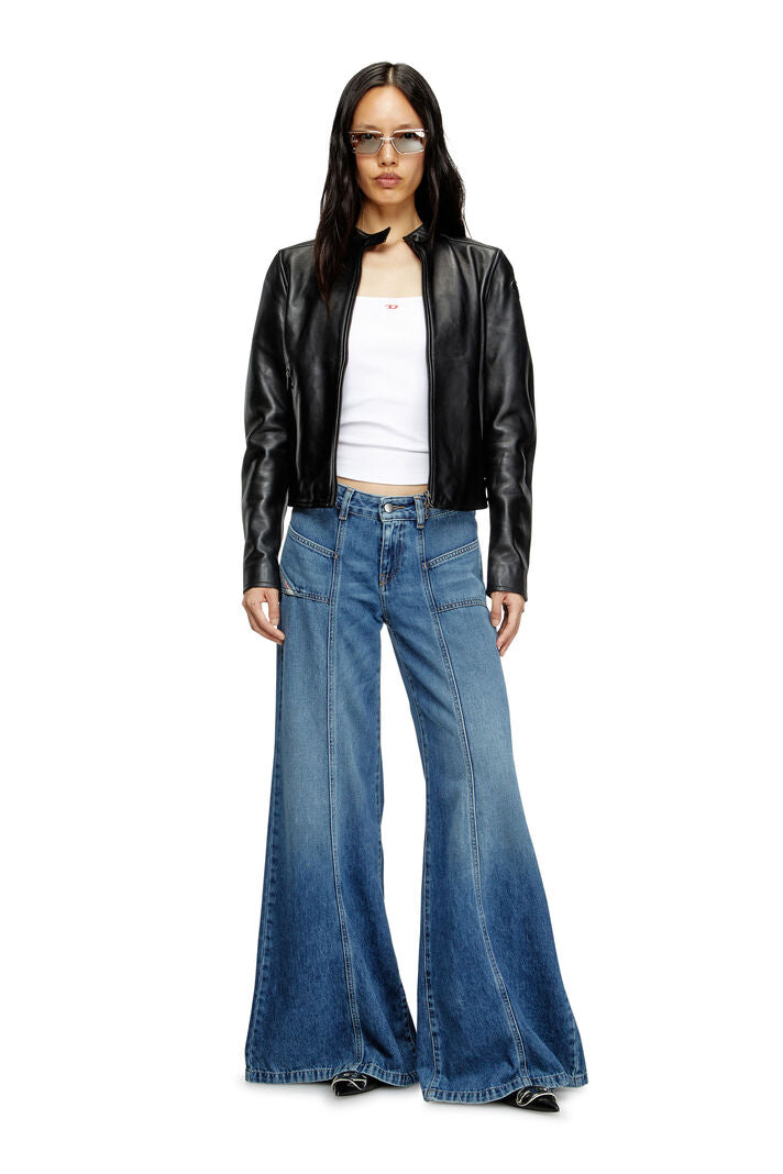 Person wearing a black leather jacket and blue jeans on a white background