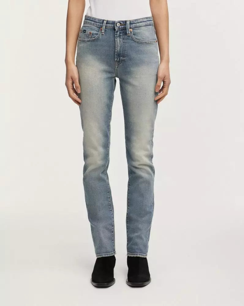 Light blue jeans worn by a person on a white background