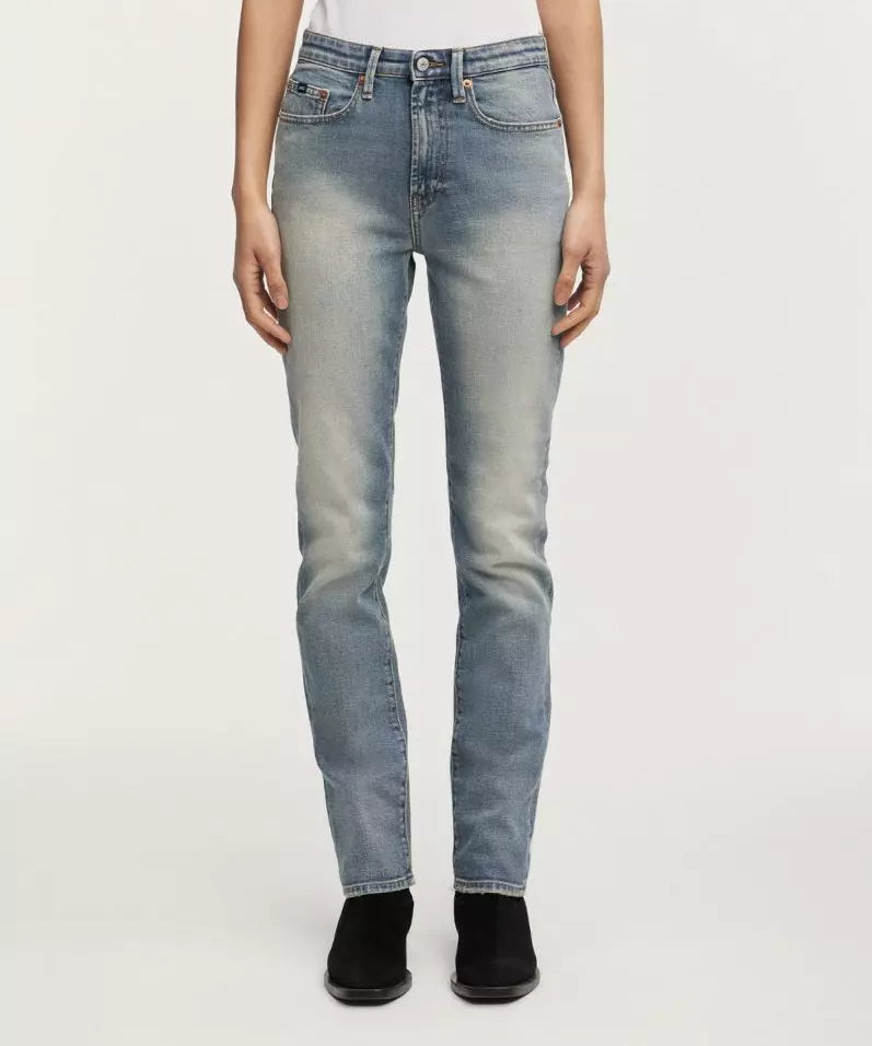 Light blue jeans worn by a person on a white background