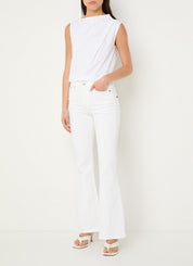 Person wearing a white sleeveless top and pants on a plain background