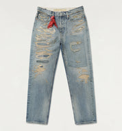 Distressed blue jeans with a red tag on a light gray background